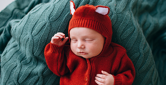 Sleeping baby in fox outfit