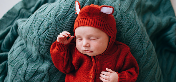 Sleeping baby in fox outfit