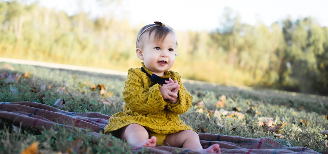 Little girl sitting in a field