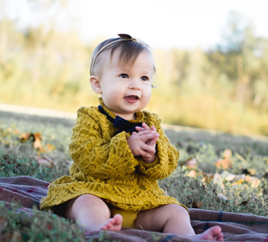 Little girl sitting in a field