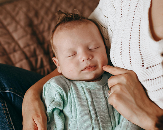 A baby in a mother's arms