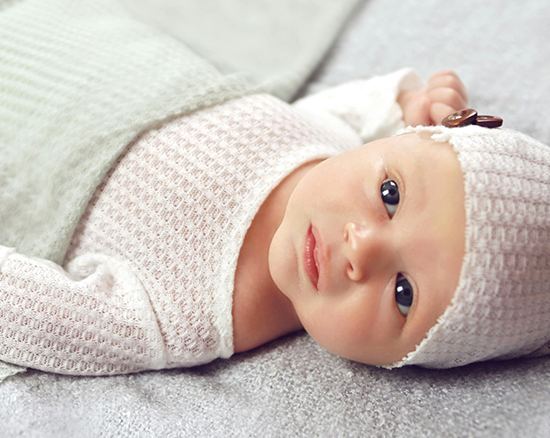 A baby girl looking up at the camera