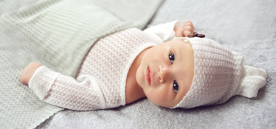 A baby girl looking up at the camera